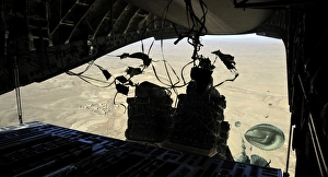 Container Delivery System bundles exit a C-17 Globemaster III during an airdrop mission Container Delivery System bundles exit a C-17 Globemaster III during an airdrop mission