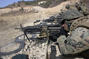 A corpsman fires an M249 Squad Automatic Weapon A corpsman fires an M249 Squad Automatic Weapon