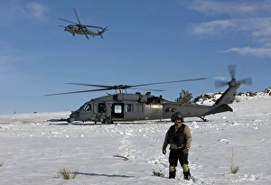 A crewmember of an HH-60G Pave Hawk surveys the landing zone A crewmember of an HH-60G Pave Hawk surveys the landing zone