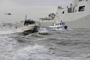 Crews from the coast guard and police departments escort USS New York as it sails Crews from the coast guard and police departments escort USS New York as it sails