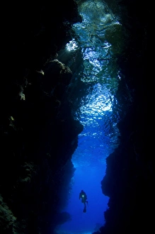 A diver explores the Lerus Cut underwater cavern, Solomons A diver explores the Lerus Cut underwater cavern, Solomons