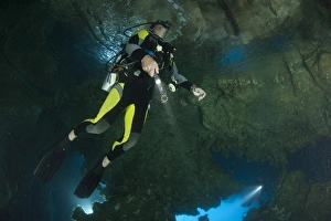 Diver exploring underwater cavern and caves, Raja Ampat, Indonesia Diver exploring underwater cavern and caves, Raja Ampat, Indonesia