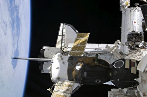 A docked Soyuz spacecraft over the docked space shuttle Atlantis A docked Soyuz spacecraft over the docked space shuttle Atlantis