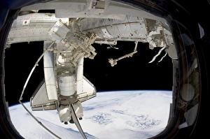 The docked space shuttle Discovery and Dextre The docked space shuttle Discovery and Dextre