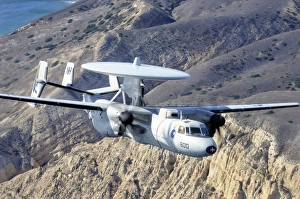 An E-2C Hawkeye aircraft flies over the Pacific Ocean An E-2C Hawkeye aircraft flies over the Pacific Ocean