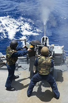 Electronics Technician fires a 25mm machine gun aboard USS Preble Electronics Technician fires a 25mm machine gun aboard USS Preble