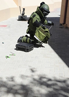 Explosive ordnance disposal technician investigates an IED Explosive ordnance disposal technician investigates an IED