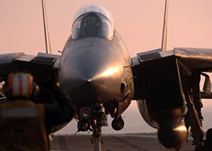 An F-14 Tomcat is directed to the steam-powered catapult aboard USS Theodore Roosevelt An F-14 Tomcat is directed to the steam-powered catapult aboard USS Theodore Roosevelt