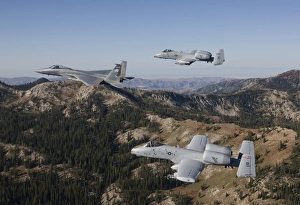 An F-15 Eagle and two A-10 Thunderbolts in flight over Central Idaho An F-15 Eagle and two A-10 Thunderbolts in flight over Central Idaho