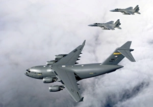F-15B Eagles escort the first Hawaii-based C-17 Globemaster III to its home F-15B Eagles escort the first Hawaii-based C-17 Globemaster III to its home