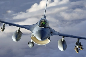 An F-16 Fighting Falcon soars through the sky An F-16 Fighting Falcon soars through the sky