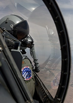An F-16 pilot checks the position of his wingman during a test mission An F-16 pilot checks the position of his wingman during a test mission