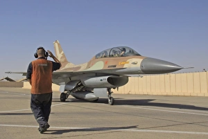 An F-16B Netz of the Israeli Air Force gets the take off sign from the ground crew An F-16B Netz of the Israeli Air Force gets the take off sign from the ground crew