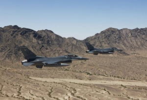 Two F-16s fly in formation over the Arizona desert Two F-16s fly in formation over the Arizona desert