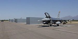 Three F-16s sit in the revetments at Davis-Monthan Air Force Base Three F-16s sit in the revetments at Davis-Monthan Air Force Base