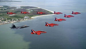Airborne Collection: A F-22 Raptor flies in formation with the Royal Air Force Aerobatic Team, The Red Arrows