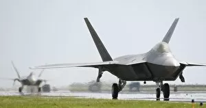 Images Dated 24th May 2001: Two F-22A Raptors taxi down the runway