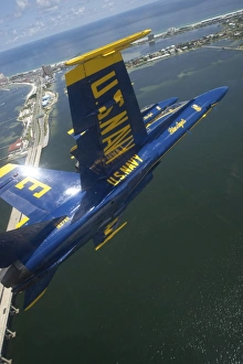 An F/A-18 Hornet of the Blue Angels over Pensacola Beach, Florida An F/A-18 Hornet of the Blue Angels over Pensacola Beach, Florida