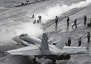 An F/A-18C Hornet taxies to a steam-powered catapult on the flight deck of USS Theodore An F/A-18C Hornet taxies to a steam-powered catapult on the flight deck of USS Theodore