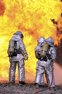 Firefighters extinguish an aircraft fire during a training exercise Firefighters extinguish an aircraft fire during a training exercise