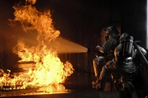 Firefighters extinguish a simulated battery fire Firefighters extinguish a simulated battery fire