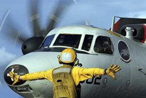 Images Dated 2nd January 2006: A flight deck director signals the pilot of an E-2C Hawkeye to spread his wings