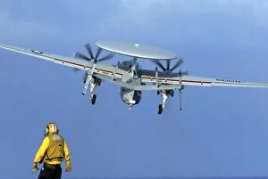 Images Dated 2nd January 2006: A flight deck director watches an E-2C Hawkeye taking off
