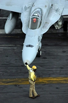 Flight Deck Officer monitors the movement of flight deck personnel from the nose Flight Deck Officer monitors the movement of flight deck personnel from the nose
