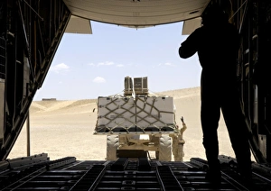 A forklift loads cargo onto a C-130 Hercules A forklift loads cargo onto a C-130 Hercules