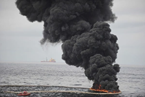 Gathered concentrated oil burns during a controlled oil fire in the Gulf of Mexico Gathered concentrated oil burns during a controlled oil fire in the Gulf of Mexico