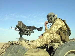 Images Dated 12th November 2004: A gunner sits atop a British Army WMIK Land Rover