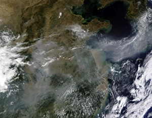 <b class=qtipBold><figcaption>Haze across the North China Plain</figcaption></b><br>October 2, 2009 - Gray-white haze blankets patches of the North China Plain and the mountain landscape to its south in this satellite image. The haze flows out of China in an arcing ribbon that stretches across the Yellow Sea and covers the Korean Peninsula.<br><em>© Stocktrek Images</em> Haze across the North China Plain