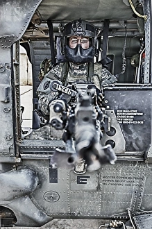 HDR image of a UH-60 Black Hawk door gunner manning a M240 machine gun HDR image of a UH-60 Black Hawk door gunner manning a M240 machine gun