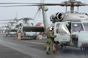 Helicopter crews change out on the flight deck aboard USS Theodore Roosevelt Helicopter crews change out on the flight deck aboard USS Theodore Roosevelt