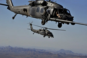 Two HH-60 Pave Hawk helicopters prepare for aerial refueling Two HH-60 Pave Hawk helicopters prepare for aerial refueling