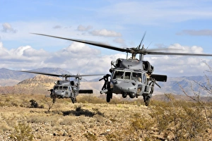 Two HH-60 Pavehawk helicopters preparing to land Two HH-60 Pavehawk helicopters preparing to land