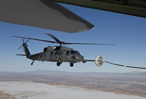 An HH-60G Pave Hawk conducts aerial refueling from an HC-130 An HH-60G Pave Hawk conducts aerial refueling from an HC-130