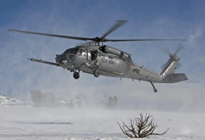 An HH-60G Pave Hawk flys low over a landing zone in New Mexico An HH-60G Pave Hawk flys low over a landing zone in New Mexico