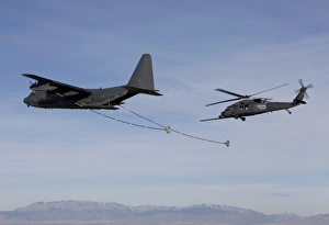 An HH-60G Pave Hawk prepares for aerial refueling from an HC-130 An HH-60G Pave Hawk prepares for aerial refueling from an HC-130