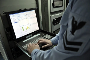 Information Systems Technician monitors network activity from a laptop Information Systems Technician monitors network activity from a laptop