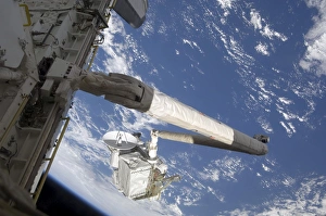 The Integrated Cargo Carrier in the grasp of the shuttles remote manipulator system arm The Integrated Cargo Carrier in the grasp of the shuttles remote manipulator system arm