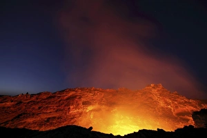 Lava lake illuminating walls of pit crater at night, Erta Ale volcano, Danakil Depression Lava lake illuminating walls of pit crater at night, Erta Ale volcano, Danakil Depression