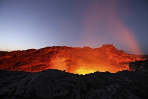 Lava lake illuminating walls of pit crater at night, Erta Ale volcano, Danakil Depression Lava lake illuminating walls of pit crater at night, Erta Ale volcano, Danakil Depression