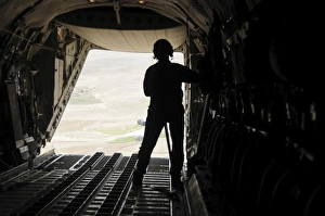 A loadmaster watches supplies airdrop out of the C-27J Spartan A loadmaster watches supplies airdrop out of the C-27J Spartan