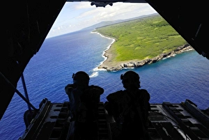 Loadmasters look out over Tumon Bay from a C-130 Hercules Loadmasters look out over Tumon Bay from a C-130 Hercules