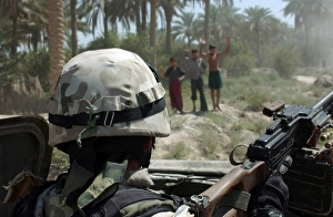 Local Iraqi children wave to a Polish Army Soldier manning a 7.62 mm PK machine gun Local Iraqi children wave to a Polish Army Soldier manning a 7.62 mm PK machine gun