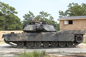 An M1A1 Abrams tank takes a defensive position on a simulated enemy town An M1A1 Abrams tank takes a defensive position on a simulated enemy town