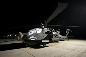 Maintenance crew work on an AH-64D Apache Longbow at night Maintenance crew work on an AH-64D Apache Longbow at night