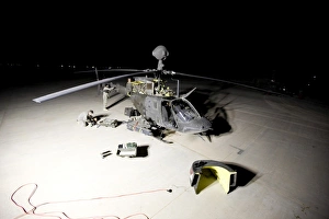 Maintenance crew works on servicing the OH-58 Kiowa before its next mission Maintenance crew works on servicing the OH-58 Kiowa before its next mission