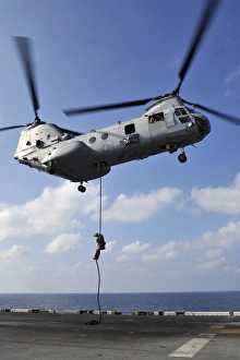 A Marine fast ropes from a CH-46E Sea Knight helicopter A Marine fast ropes from a CH-46E Sea Knight helicopter